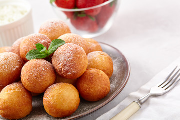 Beautiful breakfast. Cottage cheese donuts  balls  on a light background.