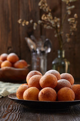 Obraz na płótnie Canvas Cottage cheese donuts balls on a dark wooden background.