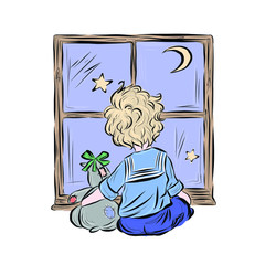 Boy watches the stars and the moon hugging soft toy while sitting at the window. 