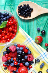 juicy red and blue berries on a green background vertical