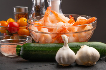 Shrimps, zucchini and garlic with spices. On a gray background, cooking saver. Cooking and...