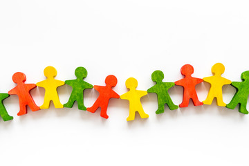 Wooden figures of people on yellow background top view. Teamwork, teambuilding concept