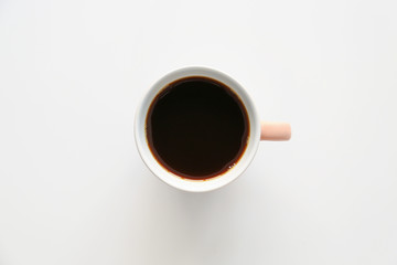 Cup of hot coffee on light background, top view