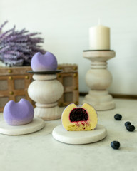 Obraz na płótnie Canvas Piece of French Mousse Mini Desserts with Purple Velvet Cover