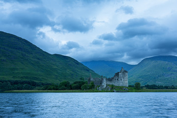 Fototapeta na wymiar Kilchurn Castle in the Scottish Highlands landscape from across a lake
