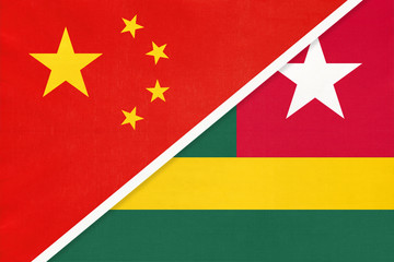 China or PRC vs Togo national flag from textile. Relationship between Asian and African countries.