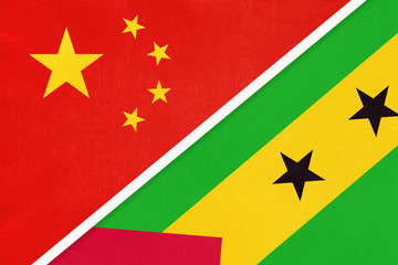 China or PRC vs Saint Thomas and Prince national flag from textile. Relationship between Asian and African countries.