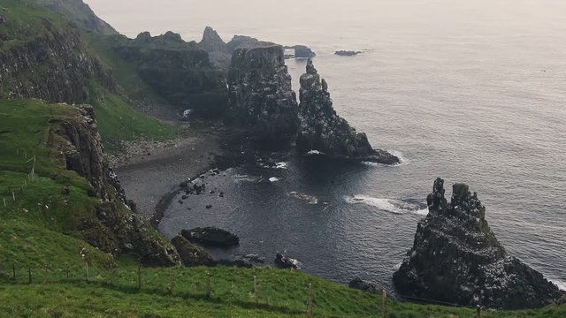 Birds flying at the beautiful Seabird Centre at the shoreline of Rathlin Island in Ireland - wide shot