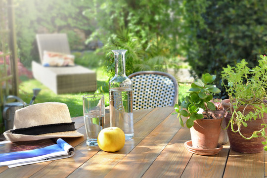 close on drink  glass and apple on a wooden table in garden  background in summer