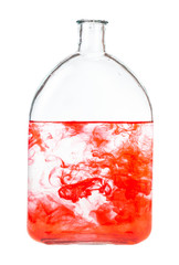 red watercolour dissolves in water in bottle