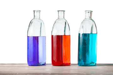 glass bottles with color ink solutions isolated