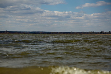 Water surface of a forest lake in windy weather.