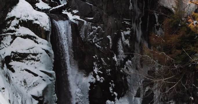 Peaceful Waterfall Cave with Snow and Icicles