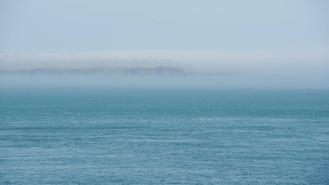 Scenic View Of Calm Blue Ocean Rippling Against The Cloudy Sky In Rathlin Island, Ireland - Wide Shot