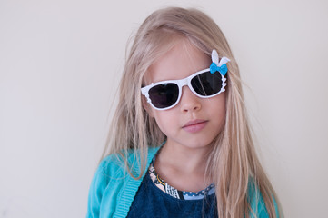 Naklejka premium Portrait of a blonde girl in dark glasses