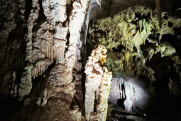 Beautiful colorful and illuminated cave with stalactites and stalagmites