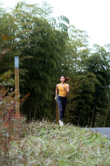 A young Asian female running outdoors