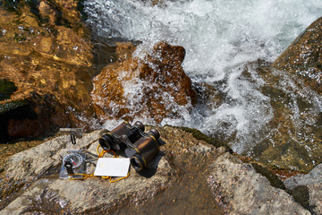 Picture of vintage binoculars, bank card and compass.
