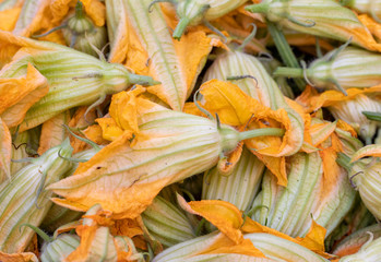 Fresh zucchini flowers at a farmers market in Italy