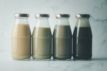 Bottle with different coffee, milk chocolate and Thai milk tea
