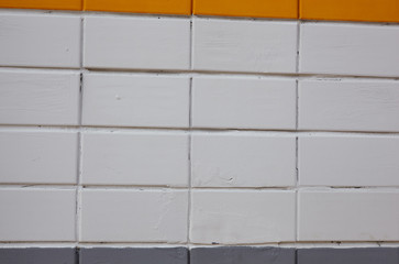 Worn orange white brick wall