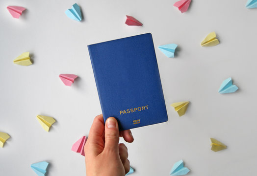 Biometric international passport in a female hand. Travel concept - Powered by Adobe