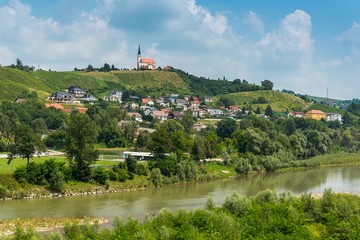 Fototapeta na wymiar Summer rural landscape with the river Drava and Church of Sv. Marija in Malecnik near Maribor, Slovenia