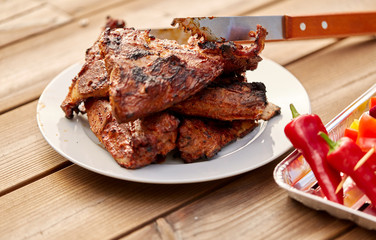 cooking, culinary and food concept - close up of grilled barbecue meat stack on plate