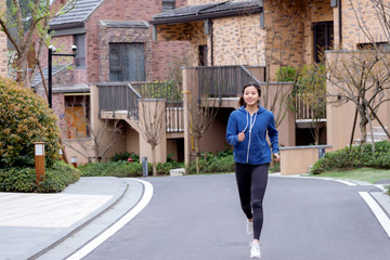 Fototapeta na wymiar A young Asian female running outdoors