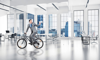Man riding bicycle at conference hall