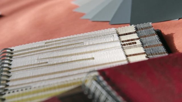 Various sample catalogs are on a table.