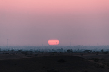 Naklejka na ściany i meble Sunset as seen from above the hill at Wankaner, Gujarat, India