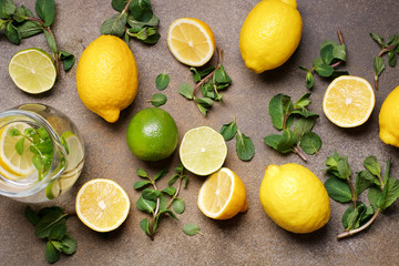 Citrus and mint herbs for making lemonade. Top view of lemon and beverage. Summer fruit drink and...