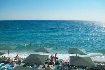 Fototapeta na wymiar Sea beach, people swim and sunbathe. Summer vacation at sea