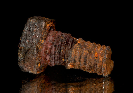 Rusted screw closeup view on black background - Powered by Adobe