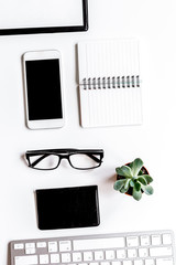 office flat lay with keyboard, phone, notebook on white background top view mockup