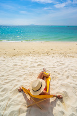 Young woman on the white sand beach