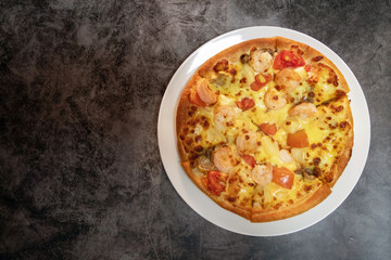Pizza seafood with prawn and tomato. Top view with free space for your text on rustic style background.