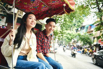 Couple traveling by Vietnamese mode of transport