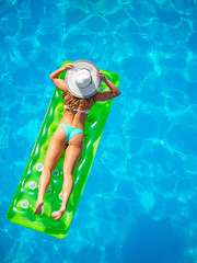 Woman on a lilo at the swimming