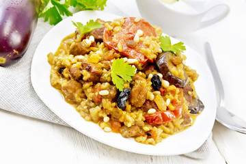 Rice with vegetables and chicken in plate on board