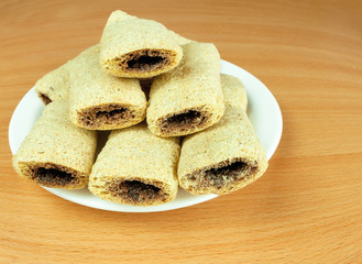Cereal biscuits with chocolate filling in plate
