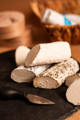 young goat cheese chevre, three pieces of oblong shape, white mold, different types