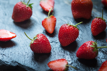 closeup of Strawberry fruit on black stone background