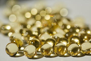 Capsules with medication, close-up, gelatin tablets with oil, vitamin or collagen.