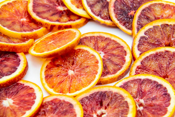Sicilian sliced ​​orange on a white plate on a white background. Sliced ripe Sicilian oranges...