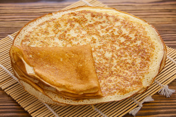 Plate with pancakes on table top view