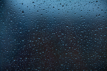 beautiful pattern with raindrops on glass in autumn