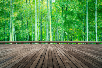 Wooden plank road and green bamboo forest