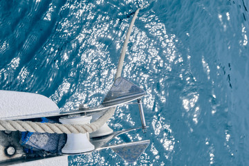 Bow of the sail boat with anchor rope. Sailing at summer sunny day. Yachting concept and sea background